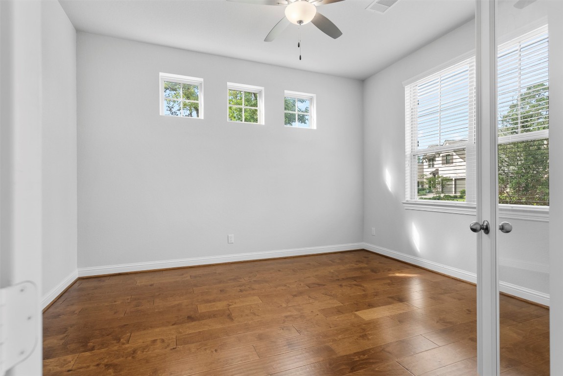 148 Gray Pne Grove Conroe, TX 77318 - Photo 10 of 46 wooden floor in an empty room with a window
