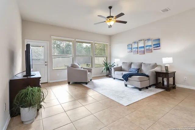 a bedroom with a bed and a ceiling fan