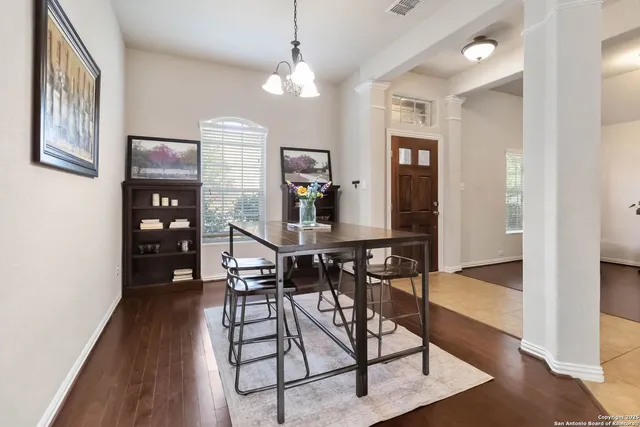 a living room with furniture a flat screen tv and a potted plant