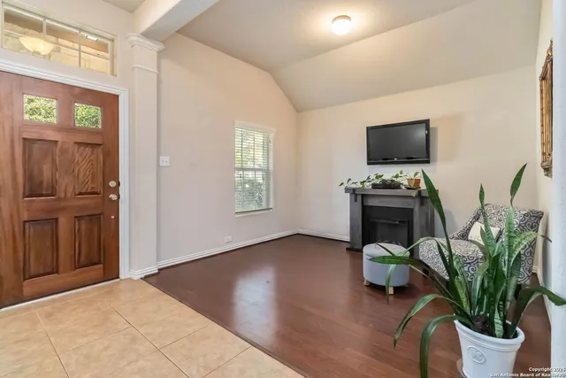 a kitchen with stainless steel appliances a sink dishwasher a stove top oven a refrigerator with island and chairs