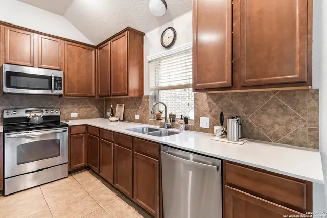 a kitchen with kitchen island a sink stove and refrigerator