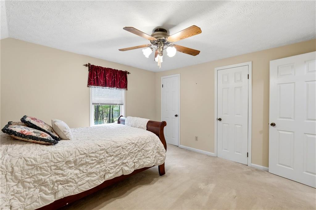 3121 Bonds Lake Road Northwest Conyers, GA 30012 - Photo 23 of 36 a bedroom with a bed and a chandelier