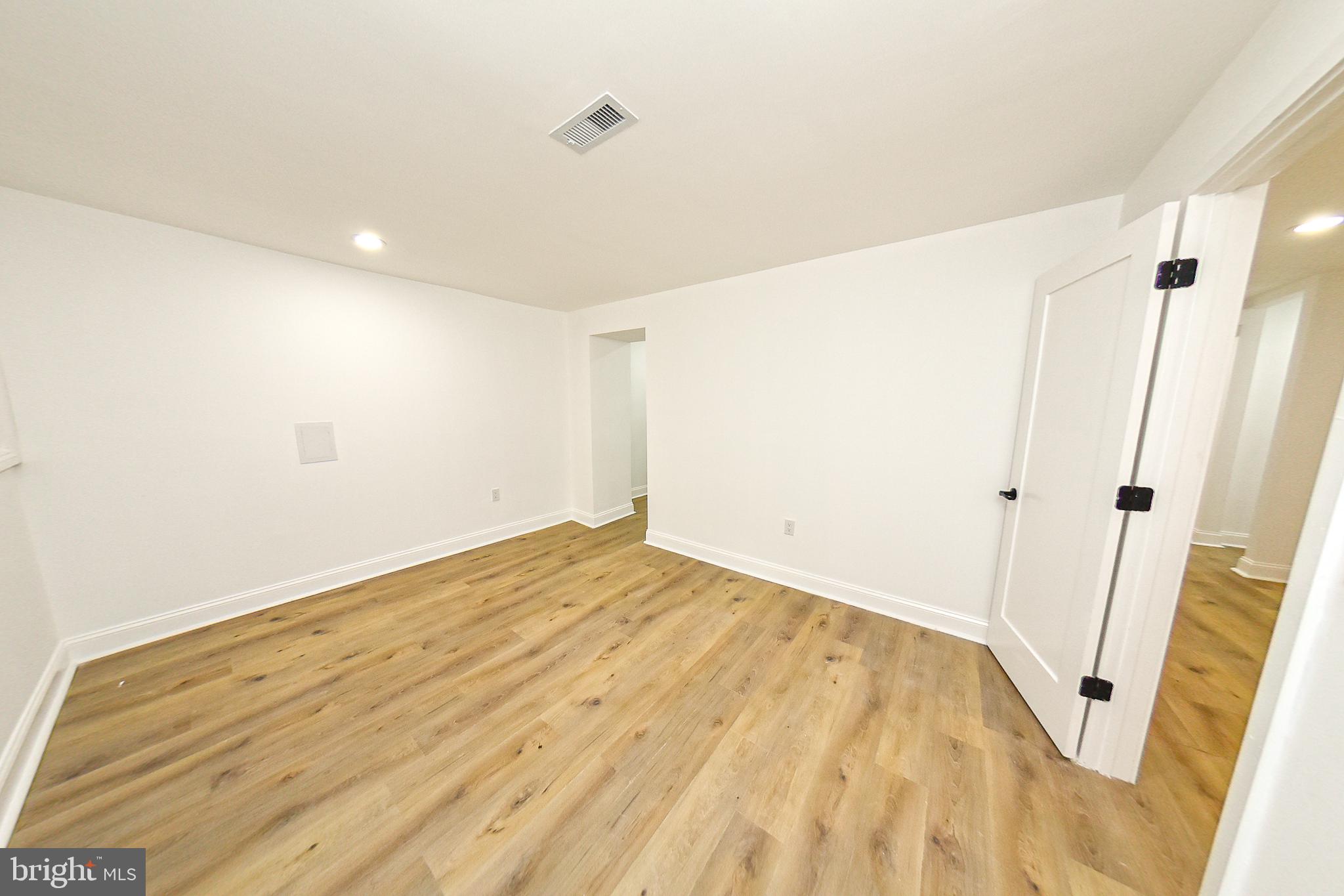 3704 Suitland Road Southeast Washington, DC 20020 - Photo 39 of 70 a view of a room with wooden floor and white walls
