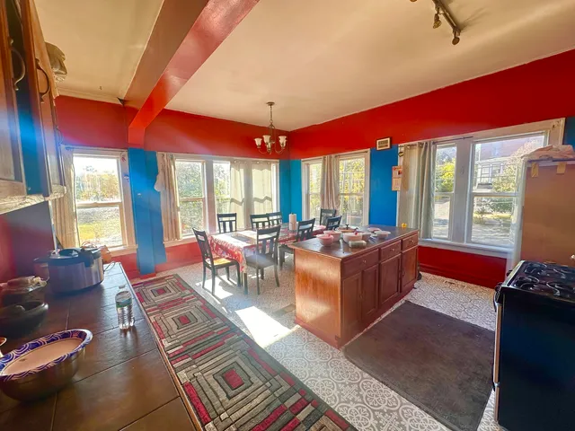 a living room filled with furniture and a floor to ceiling window