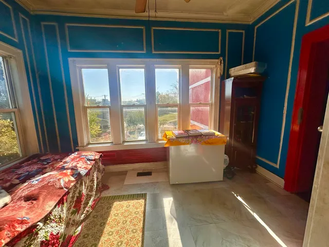 a bed sitting in a bedroom next to a window