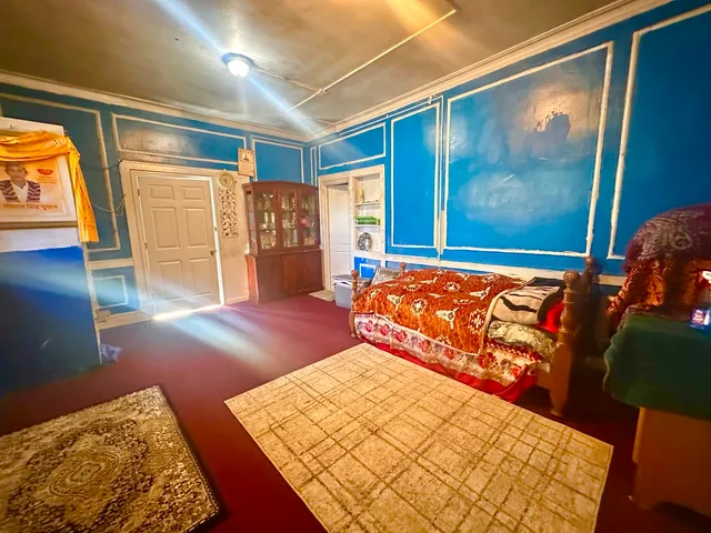 a bedroom with a large bed and a window