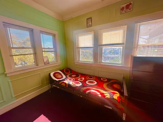 a bedroom with a bed and a mirror