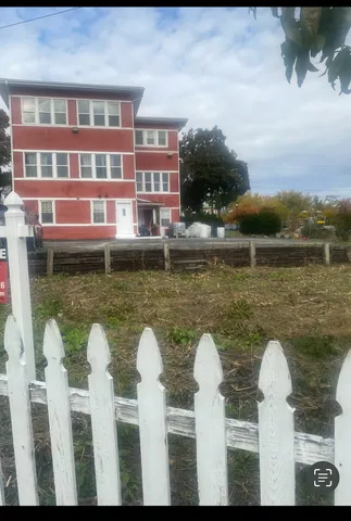 a front view of a house with wooden fence