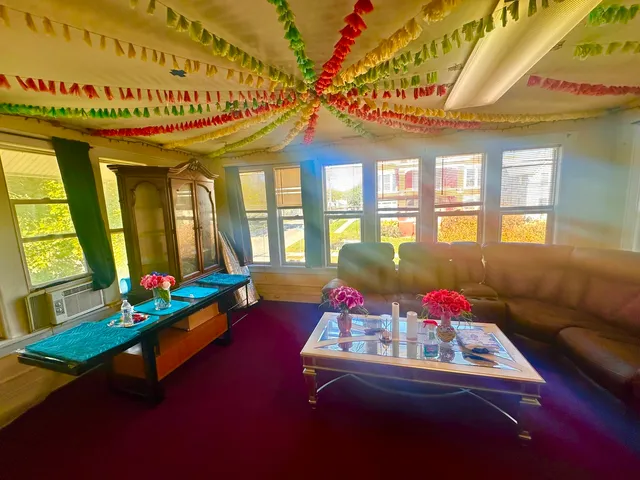 a living room with furniture and a floor to ceiling window