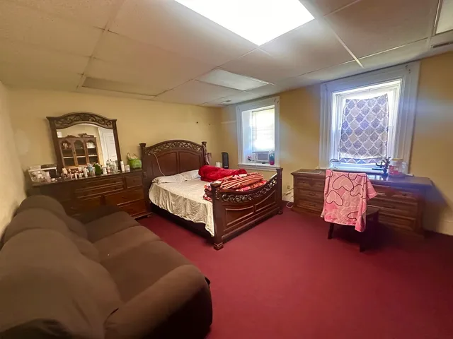 a spacious bedroom with a bed and window