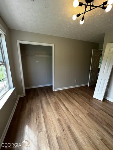 a view of a room with wooden floor