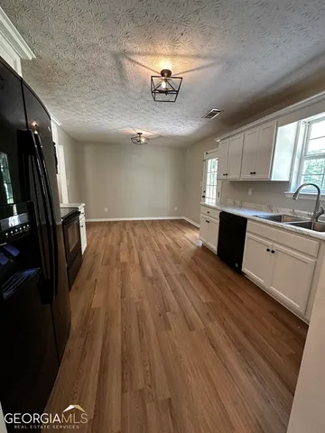 a view of a kitchen with a sink and cabinets