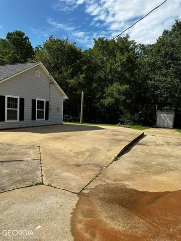 a swimming pool with trees in the background