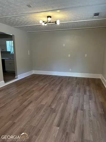a view of room with window and wooden floor
