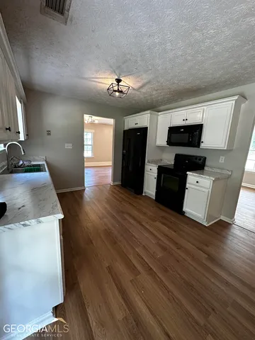 a kitchen with a sink and refrigerator