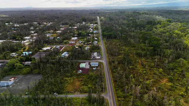a backyard of a house with table and chairs and wooden floor