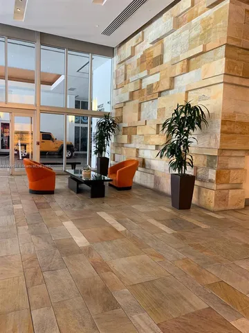 a building outdoor space with patio furniture and potted plants