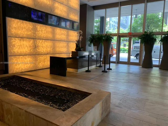 a kitchen with stainless steel appliances granite countertop a stove a sink and a large window