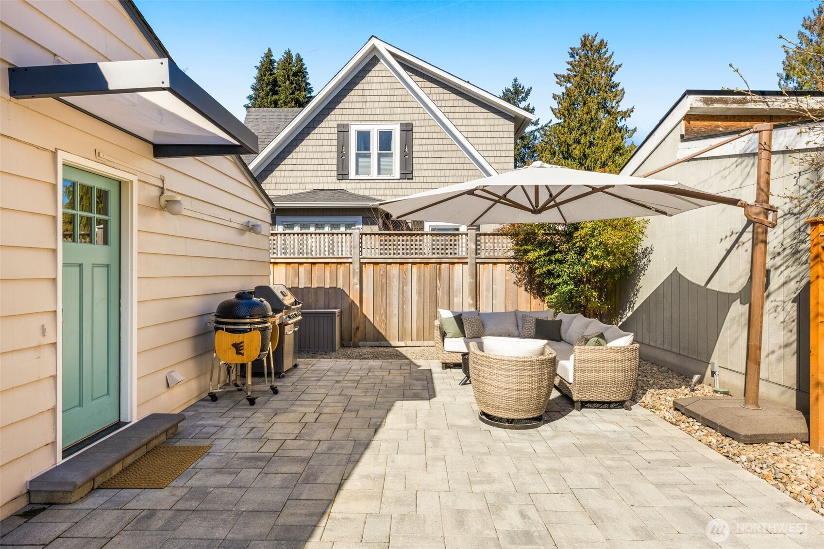 9102 12th Avenue Northeast Seattle, WA 98115 - Photo 26 of 33 a view of a patio with table and chairs potted plants and a wooden fence