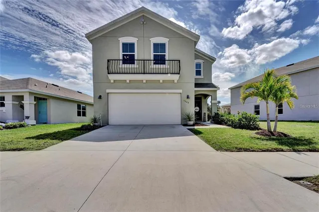 a front view of a house with a yard and a garage