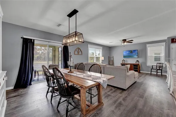 a view of a dining room with furniture window and wooden floor