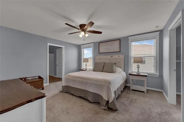 a spacious bedroom with a bed and a table in it