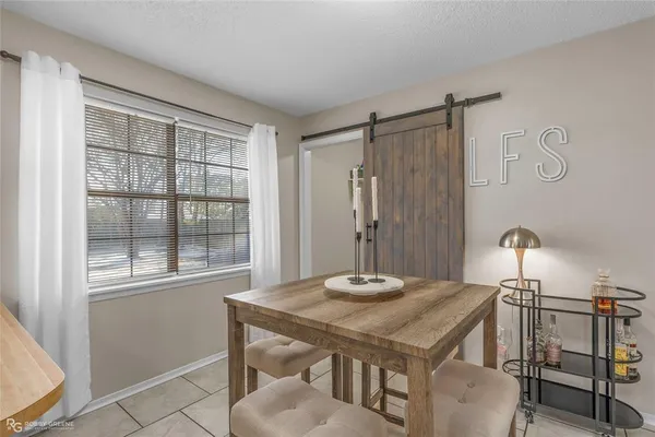 a dining room with a table and chairs