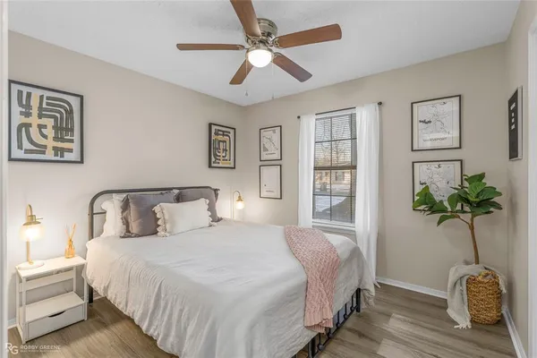 a bedroom with bed and a potted plant