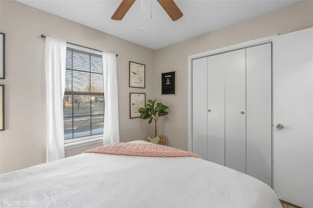 a bedroom with a large bed and a chandelier