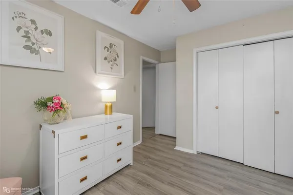a bedroom with a bed and a dresser in it