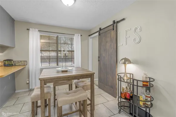 a dining room with a table and chairs