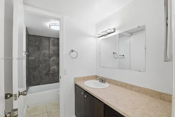 a bathroom with a shower and a bath tub