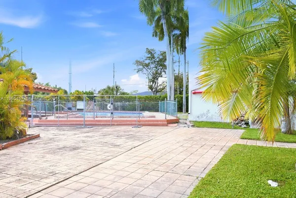a view of yard with swimming pool
