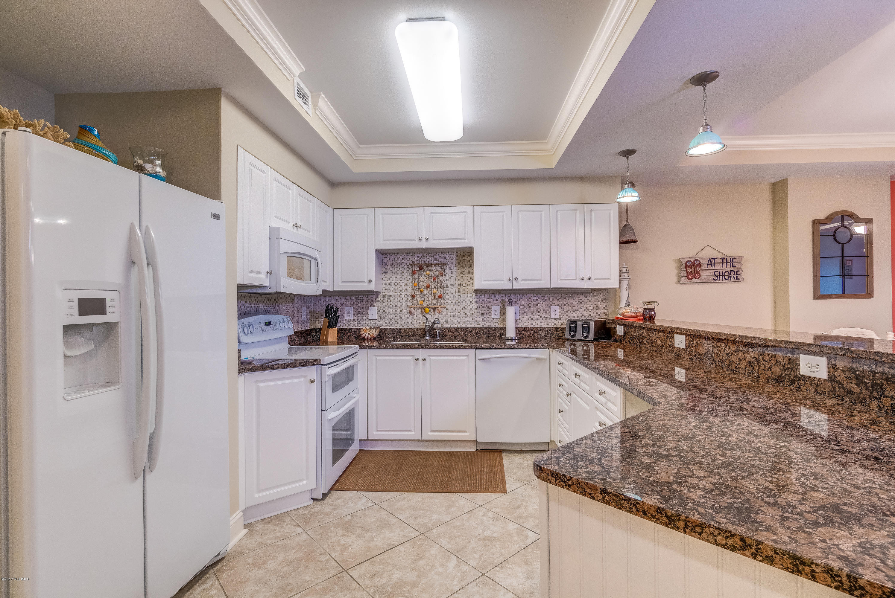 1550 Salter Path Road, Unit 206 Atlantic Beach, NC 28512 - Photo 2 of 38 Kitchen has all GE Profile appliances, double tiered granite counters & pendant lighting in addition to overhead light