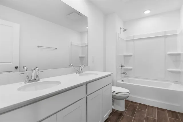 a bathroom with a sink toilet tub and shower