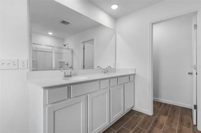 a bathroom with a double vanity sink and a mirror
