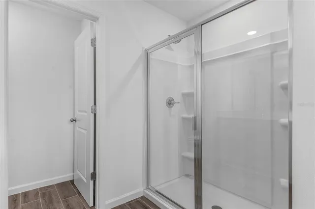 a bathroom with a glass door shower