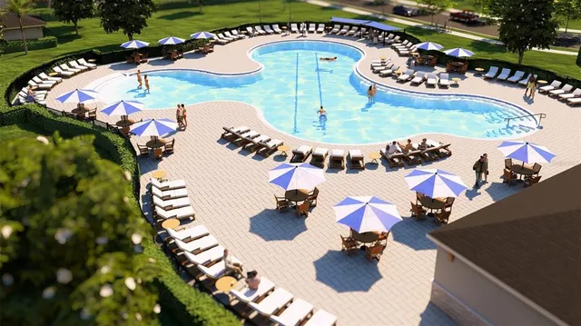 an aerial view of a swimming pool patio and outdoor seating