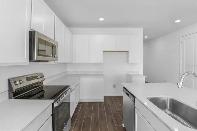 a kitchen that has a sink and a stove