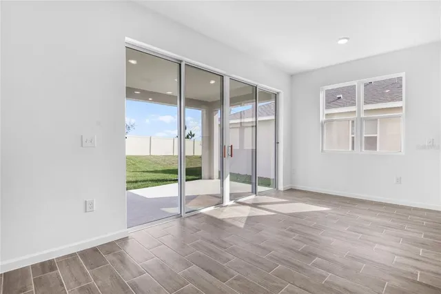 a view of an empty room with glass door