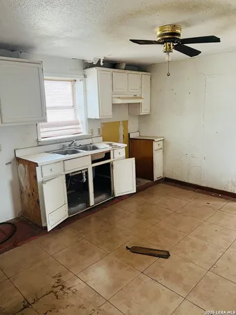 a kitchen with a stove top oven cabinets and stainless steel appliances