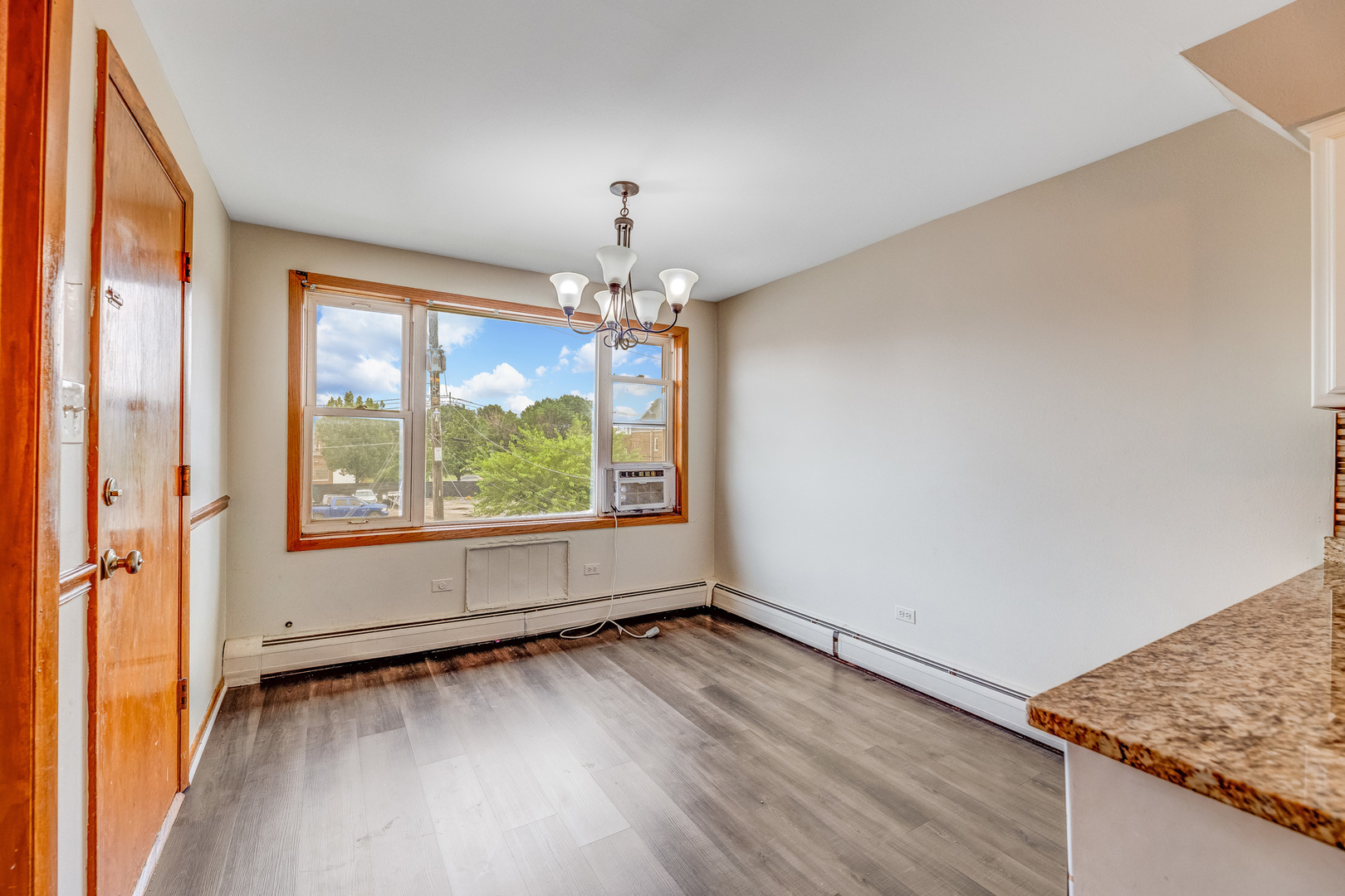 5626 West 64th Street, Unit 2 Chicago, IL 60638 - Photo 7 of 11 an empty room with wooden floor and windows