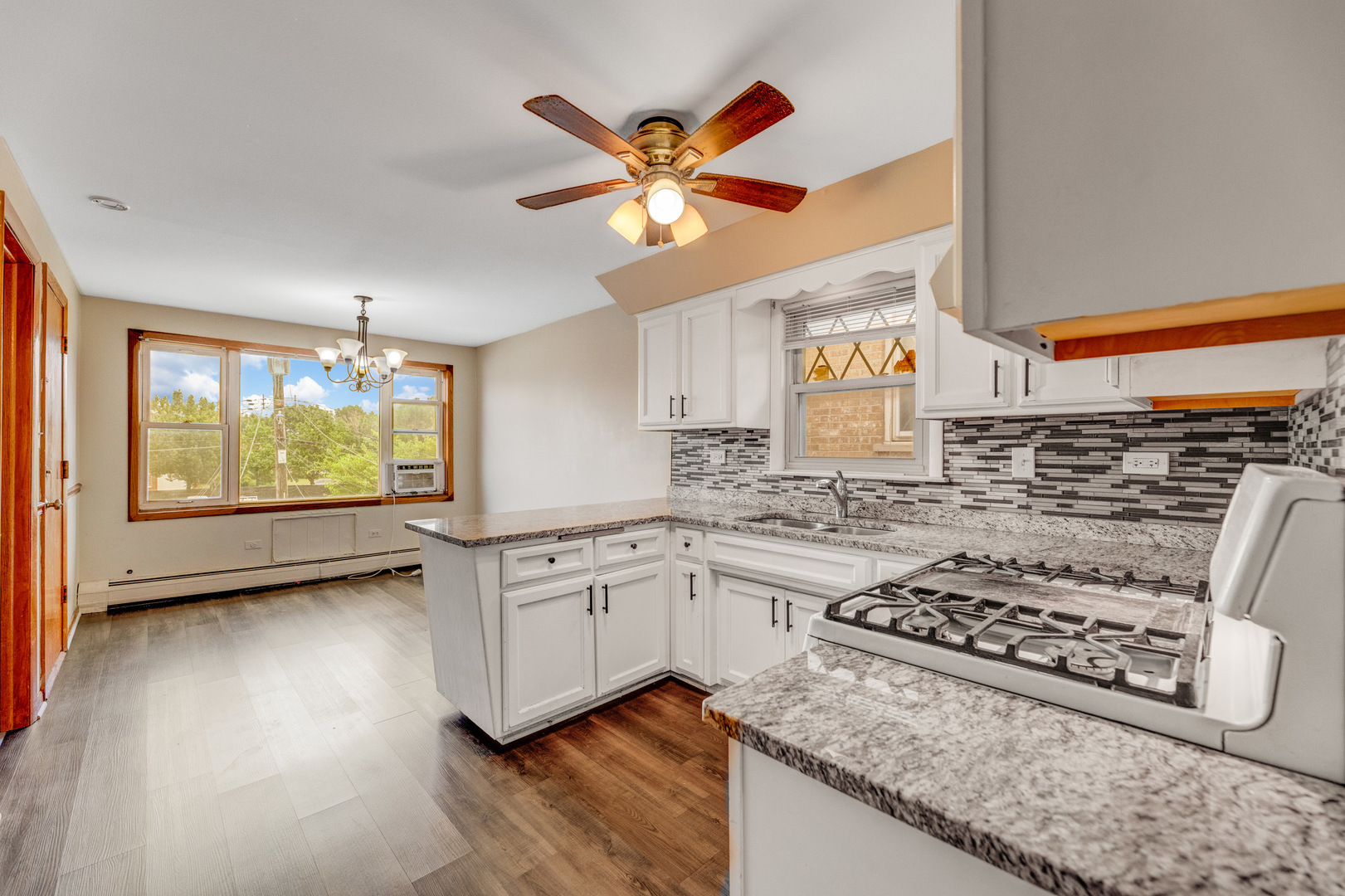 5626 West 64th Street, Unit 2 Chicago, IL 60638 - Photo 8 of 11 a kitchen with stainless steel appliances granite countertop a stove a sink and a refrigerator