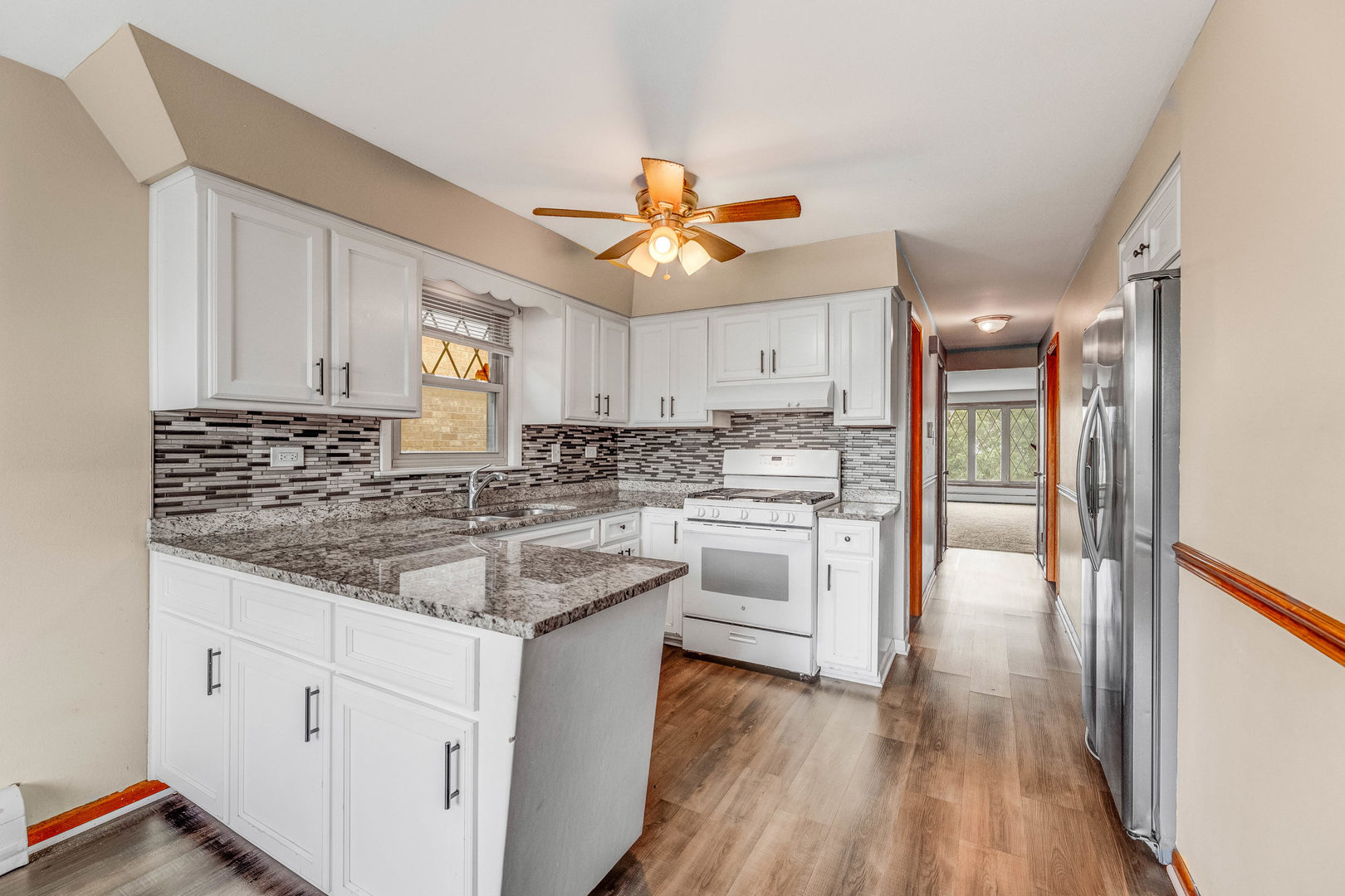 5626 West 64th Street, Unit 2 Chicago, IL 60638 - Photo 9 of 11 a kitchen with white cabinets and white appliances