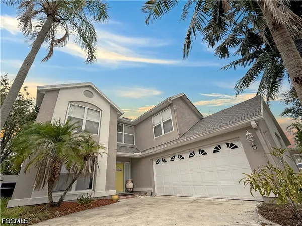 a front view of a house with tree s