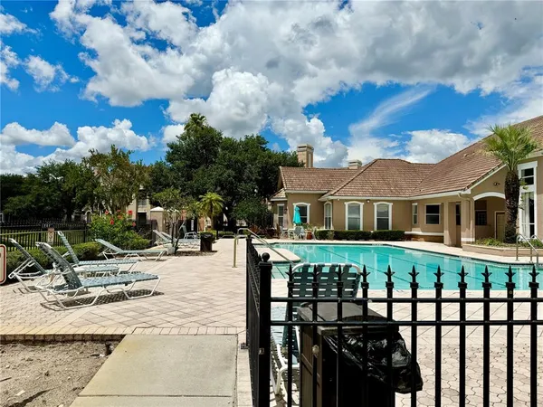 a view of a house with backyard and sitting area