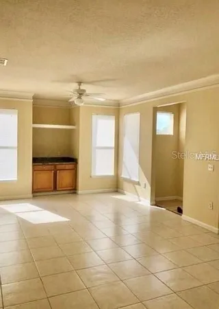 en empty room with a fireplace and windows