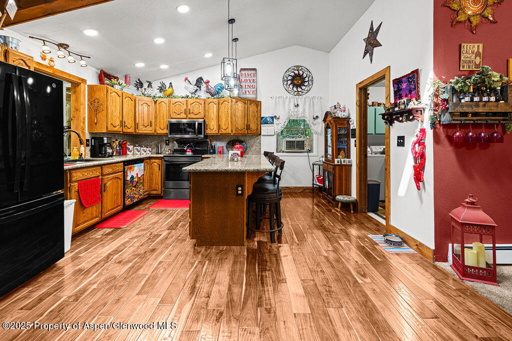 2928 Pinon Circle Craig, CO 81625 - Photo 17 of 92 a kitchen with stainless steel appliances granite countertop a refrigerator a stove top oven and a sink with cabinets