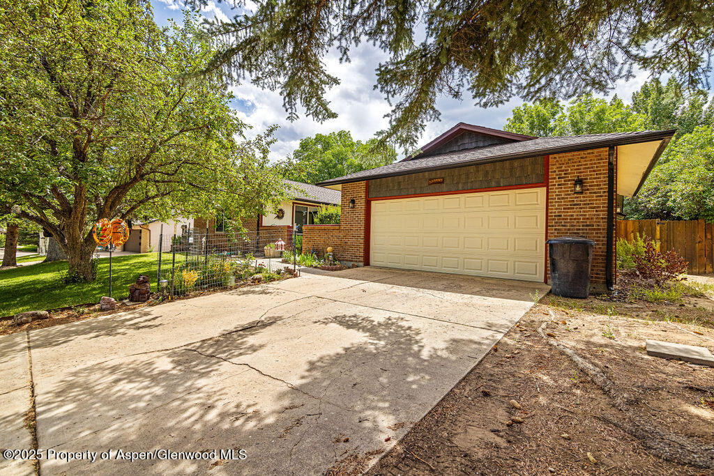 2928 Pinon Circle Craig, CO 81625 - Photo 4 of 92 a front view of a house with a yard and garage
