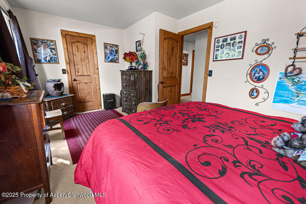 2928 Pinon Circle Craig, CO 81625 - Photo 53 of 92 a bedroom with a bed and a flat tv screen on dresser